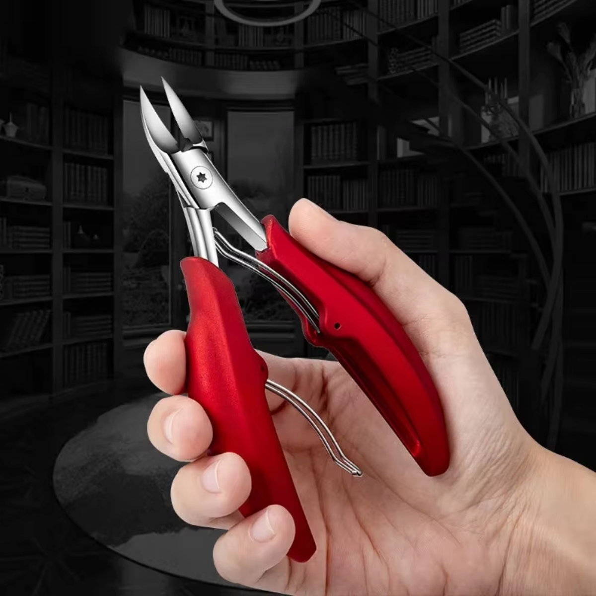 Red stainless steel toenail scissors held in hand, showing curved cutting tips