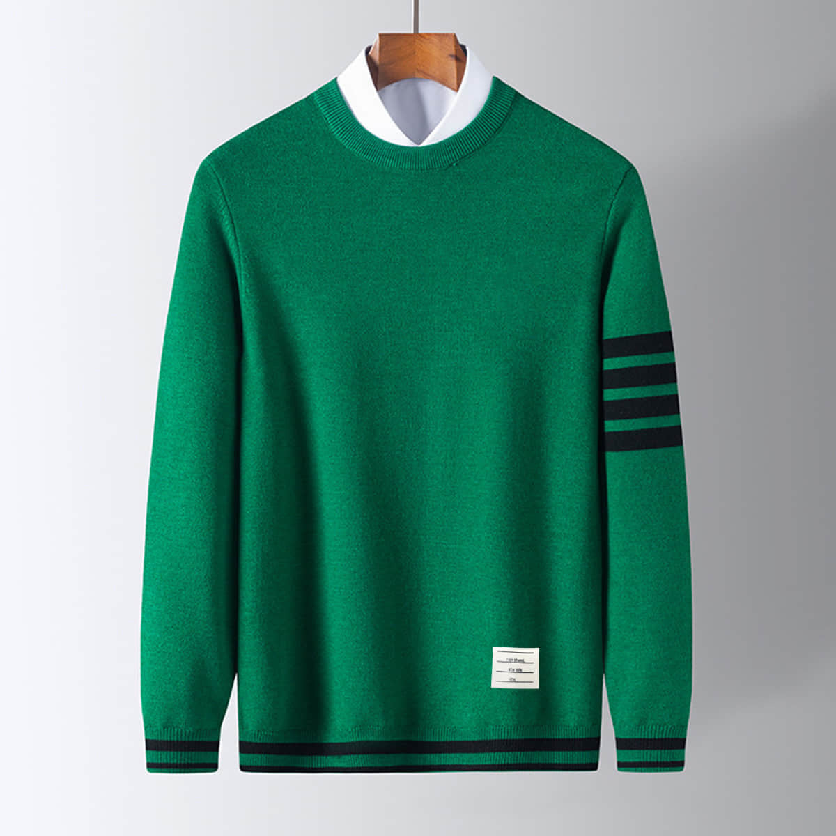 Men's pullover sweater, green knit with dark striped sleeve cuffs and hem band.