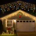 Outdoor warm white LED light curtain lights draped across a house facade