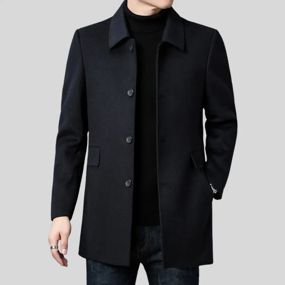 Black coat worn by a person on a gray background