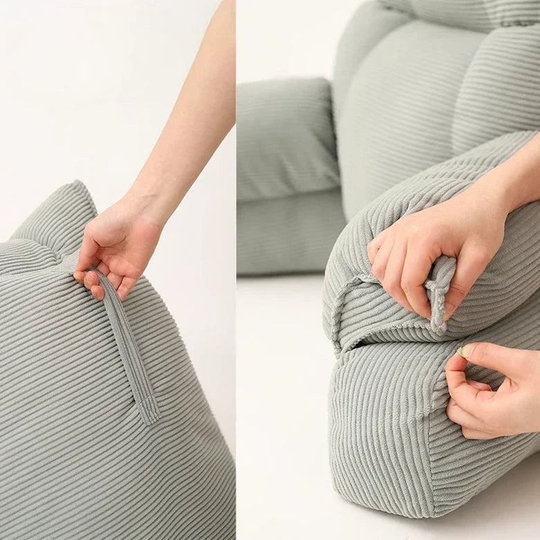 Grey striped memory foam lounge pillow with zipper detail and side arm support