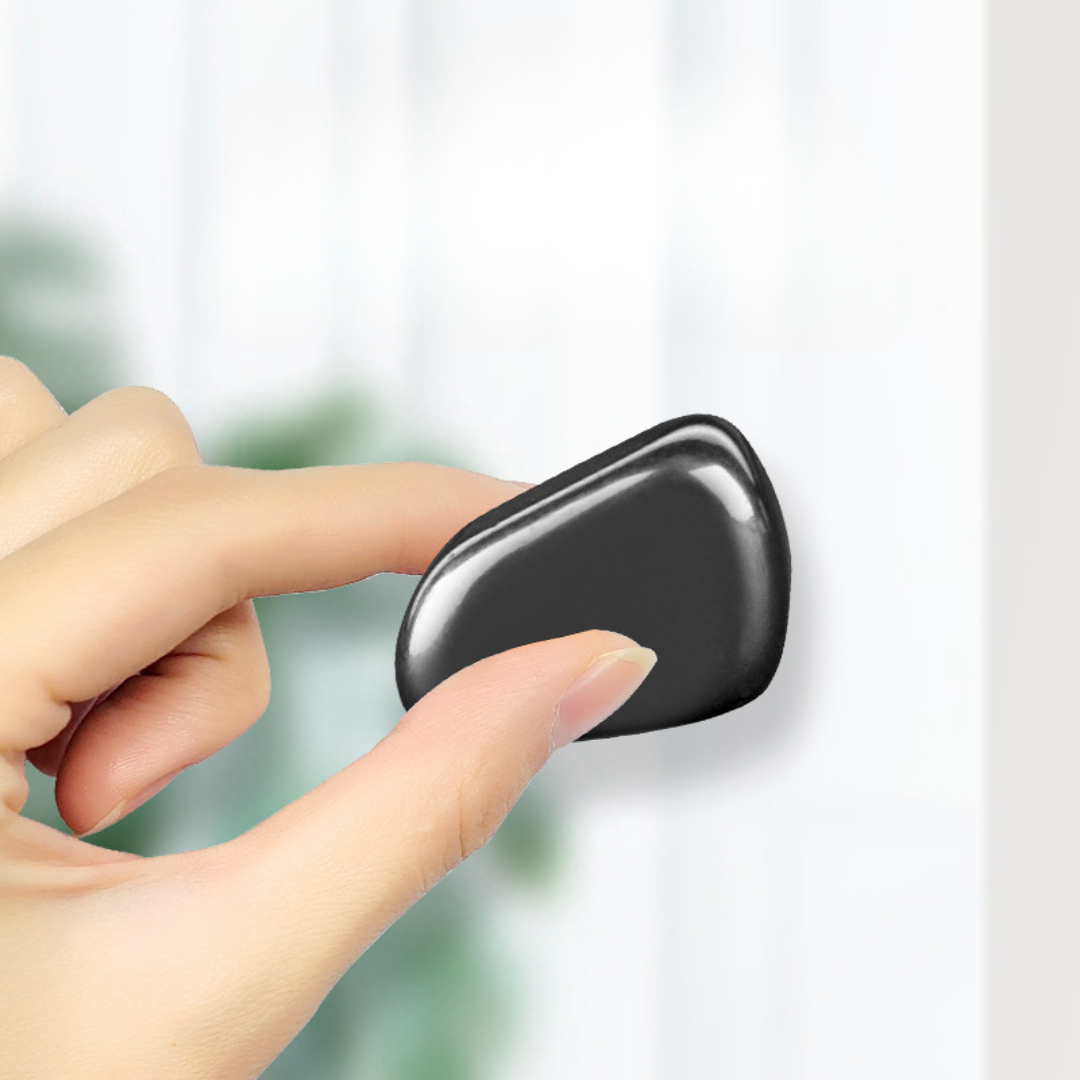 Magnetic strategy game magnet piece held by fingertips