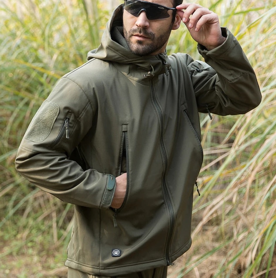 Olive-green outdoor jacket with hood, front zipper, and zippered sleeve pocket