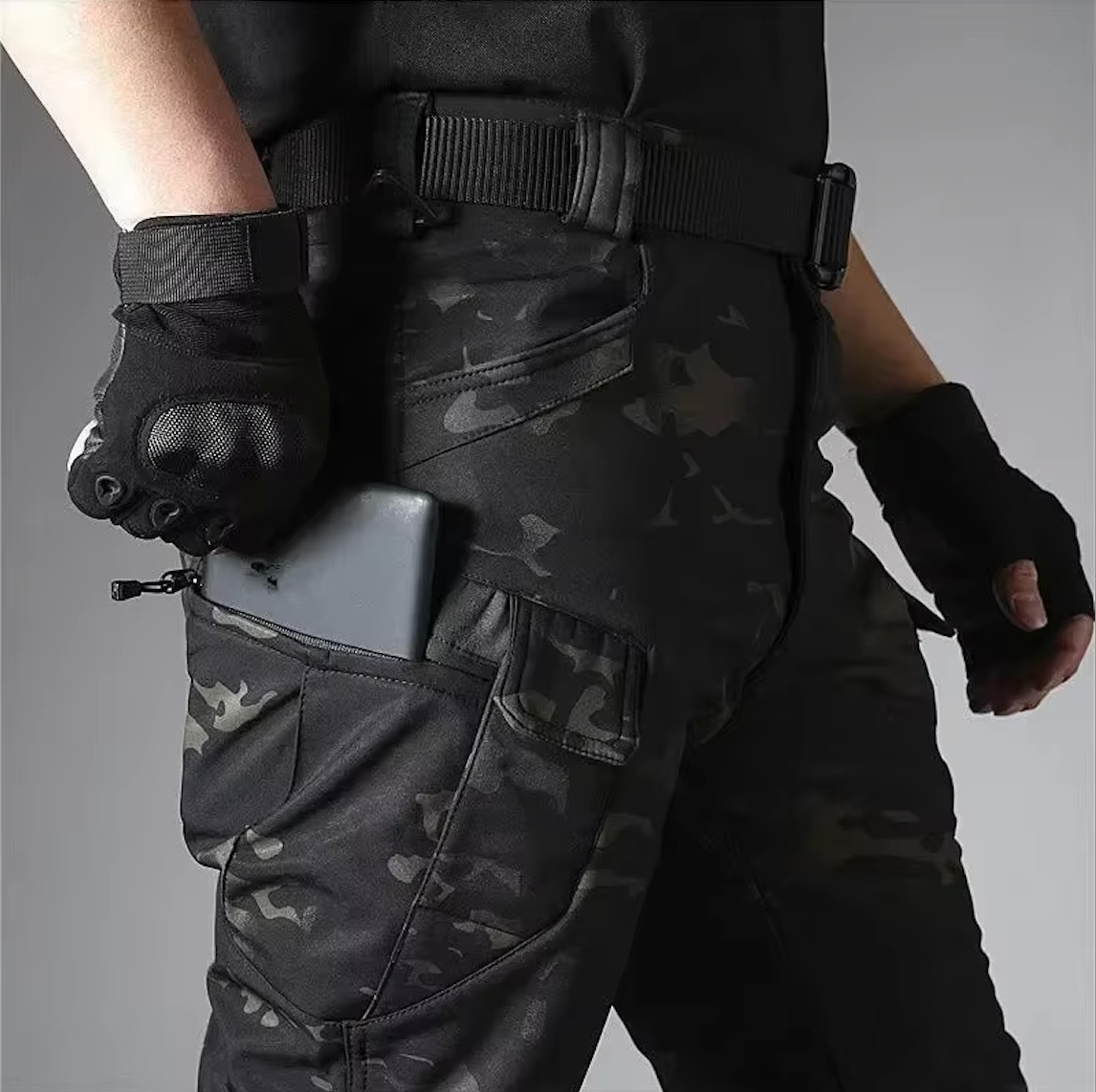 Dark camouflage outdoor pants with belt and utility pocket with zipper