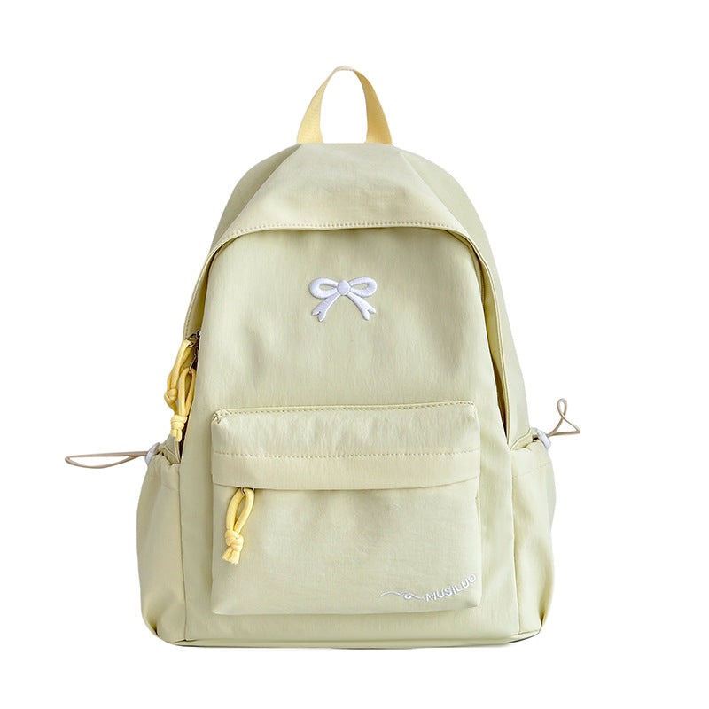 Yellow casual school backpack with bow emblem, front pocket, and side drawcords