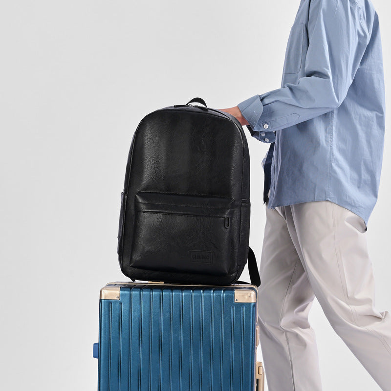 Black vegan leather executive backpack, front zip pocket and top handle