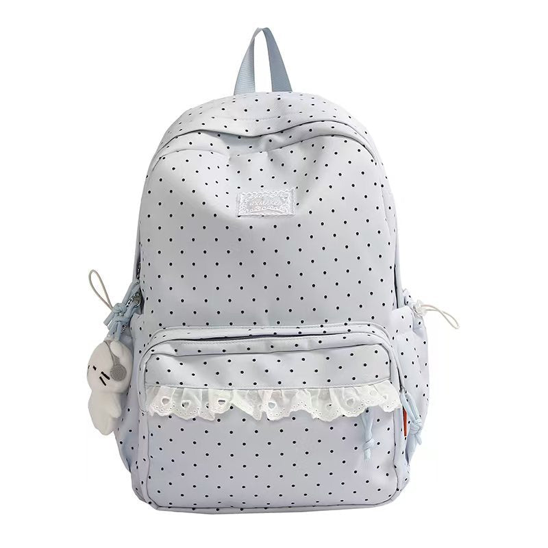 Light blue polka dot ruffled backpack with front pocket and plush keychain charm