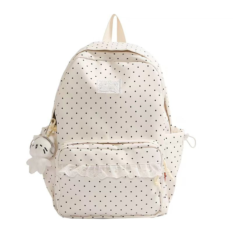 White polka dot ruffled backpack with front pocket and plush keychain charm