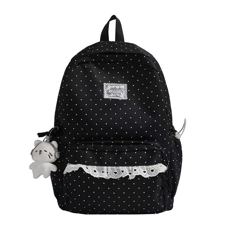 Black polka dot ruffled backpack with front pocket and plush keychain charm