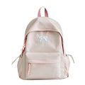Pink bow-embossed casual school backpack with front pocket and adjustable straps