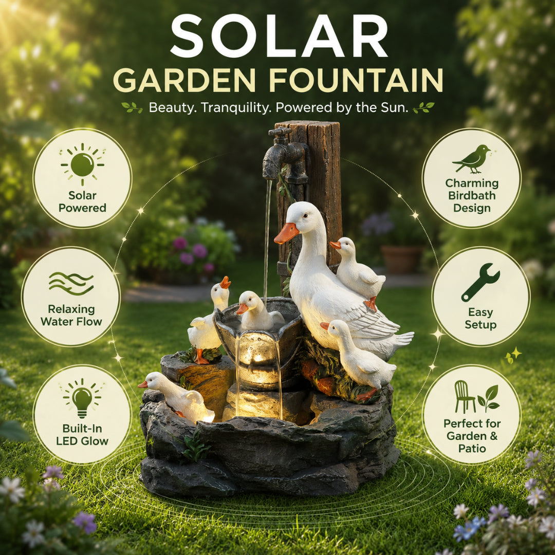 Solar garden fountain with white ducks and ducklings on dark rock pedestal