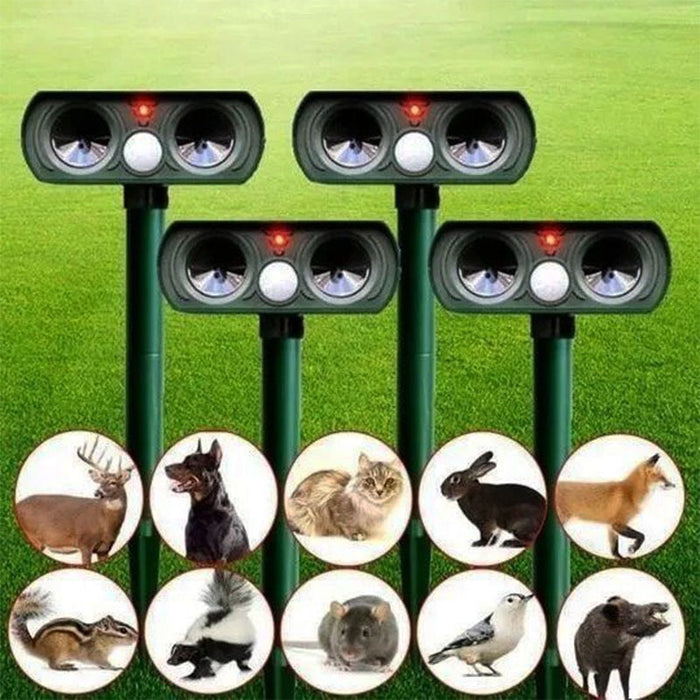 Green solar animal repeller set with four stakes and round target icons