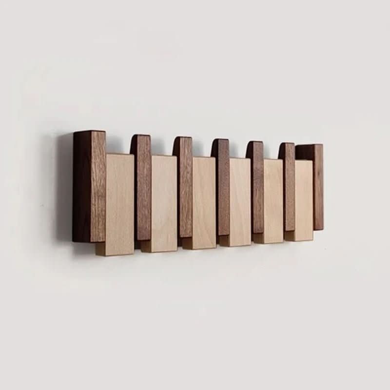 Wood wall hanger with alternating light and dark wooden pegs in a piano key style