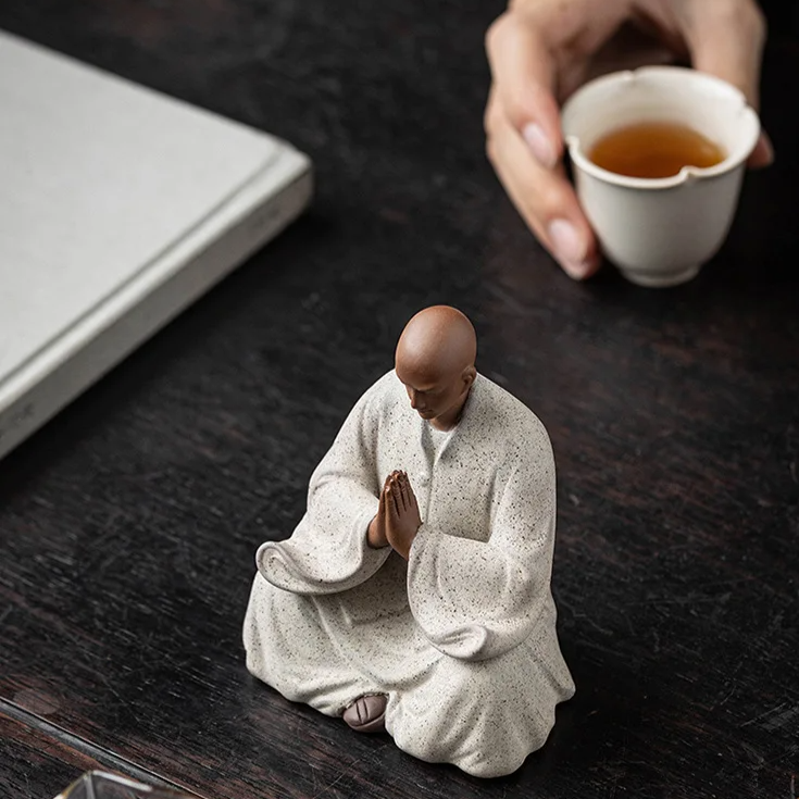 Praying monk statue with head bowed, off-white speckled finish