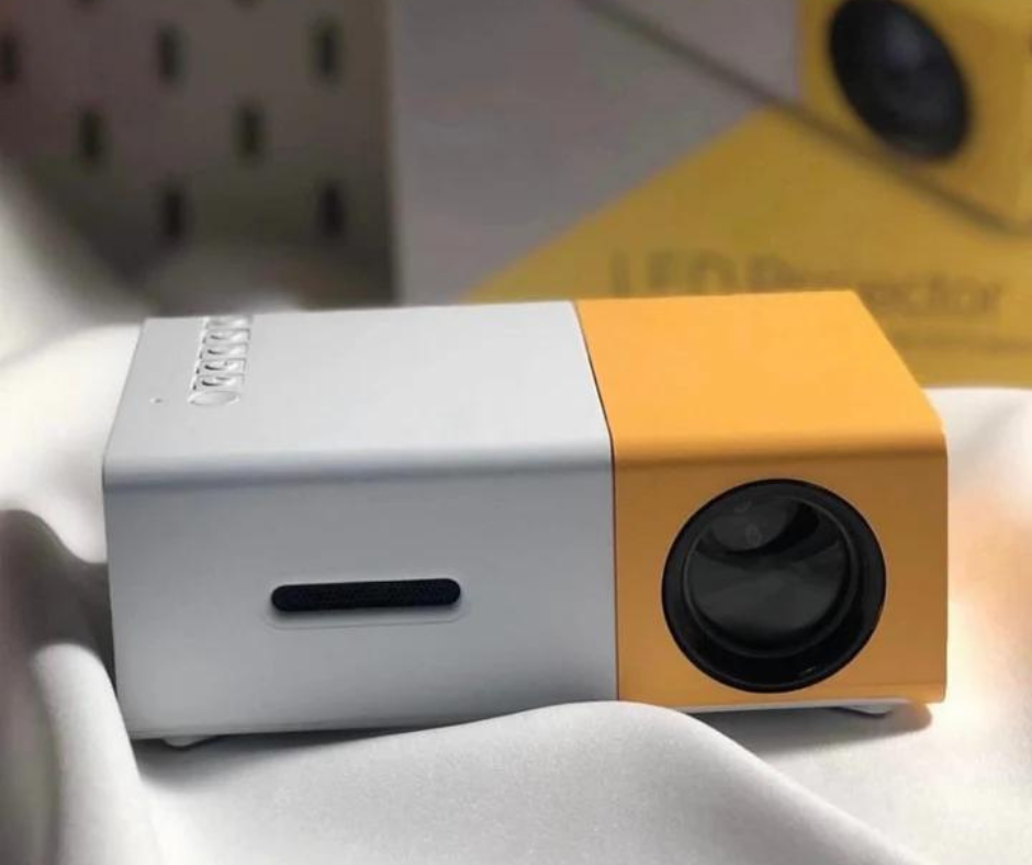 White and yellow mini projector with front lens and side handle slot detail