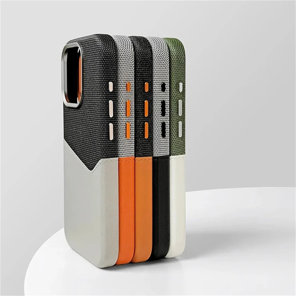 Stacked leather camera guard cases in gray, white, orange, and green, side view