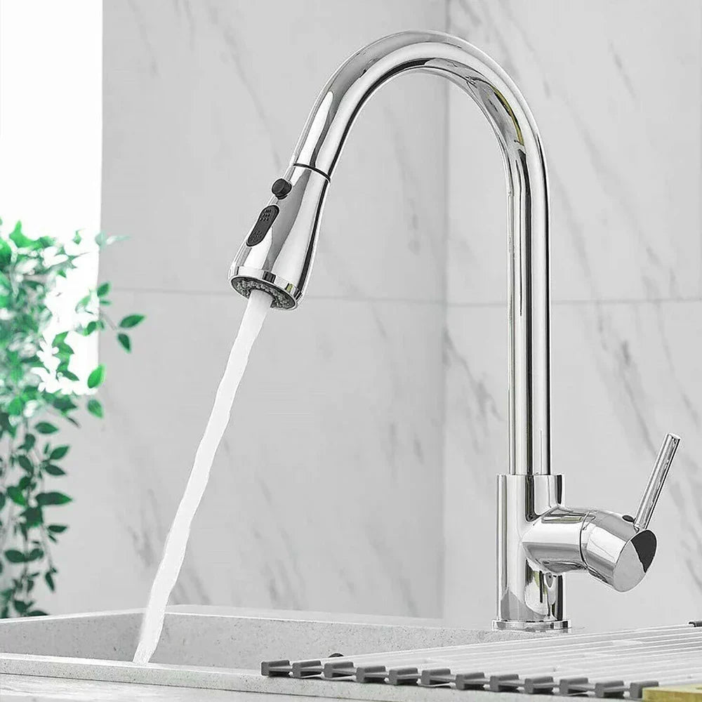 Chrome kitchen faucet with water flowing into a sink against a light gray background
