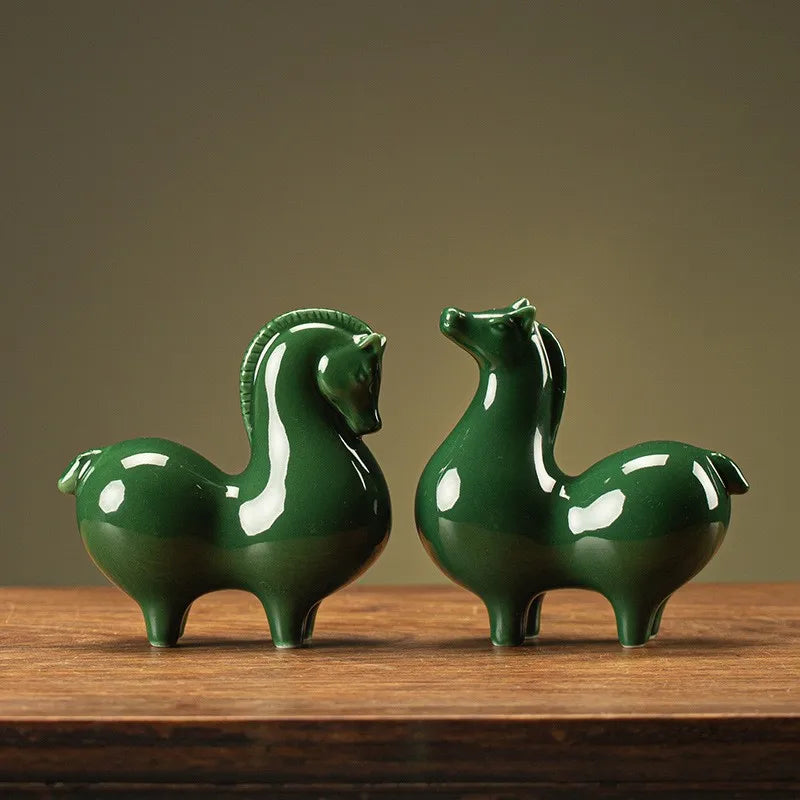Ceramic horse figurines, dark green glossy glaze, two horses facing opposite directions.
