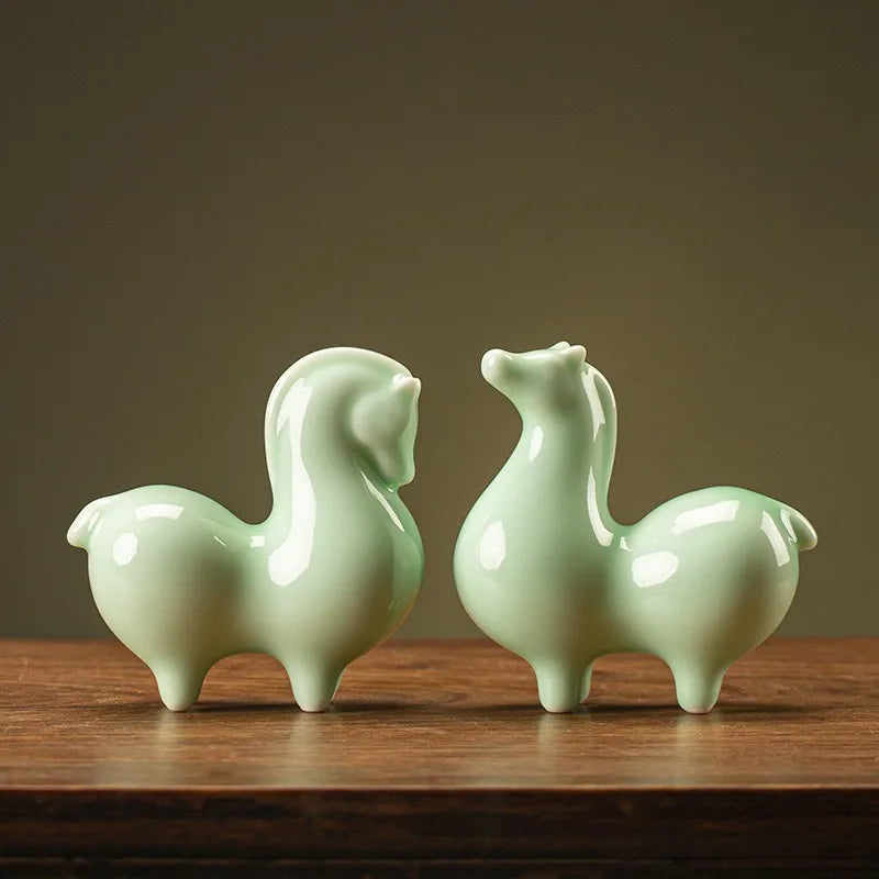 Ceramic horse figurines, light green glossy glaze, two horses side by side.