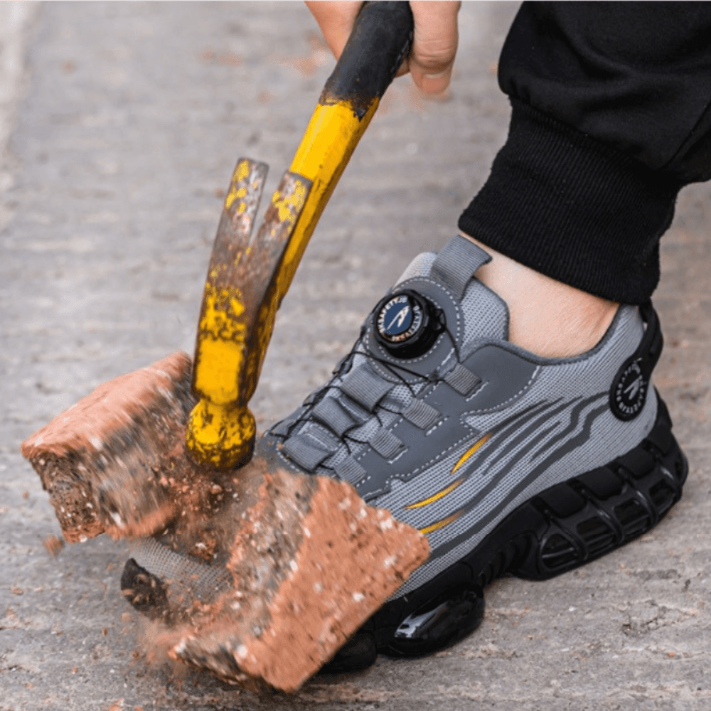 Grey steel-toe work shoe with lace-up straps and deep tread outsole