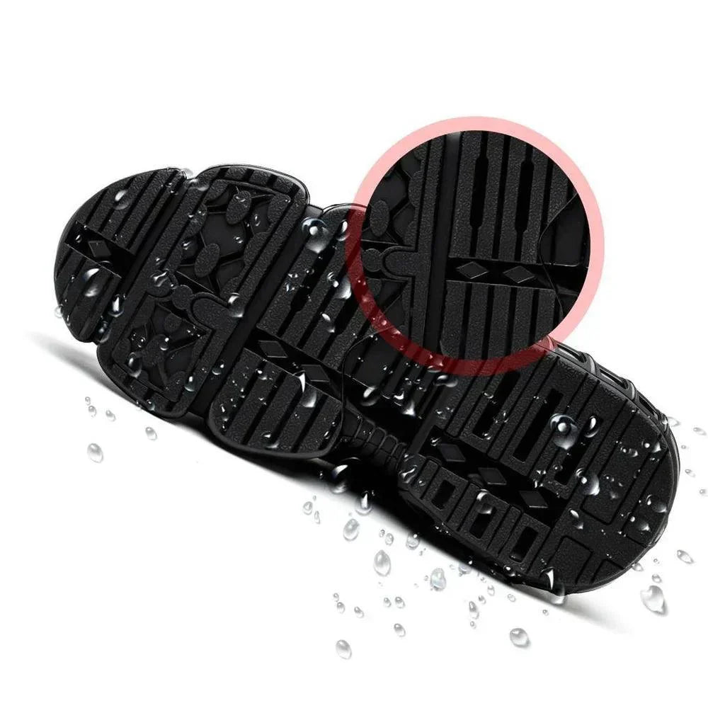Black steel-toe work shoe outsole with raised traction tread, splash-wet view