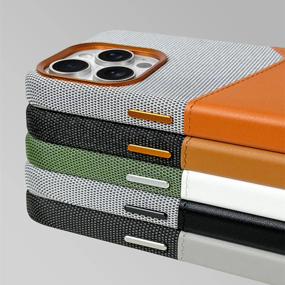 Close-up of stacked leather camera guard cases with orange, green, and black accents and slots
