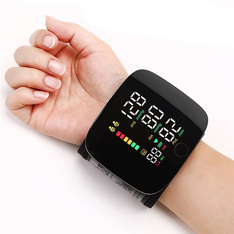 Black wrist blood pressure monitor displaying systolic/diastolic and pulse readings