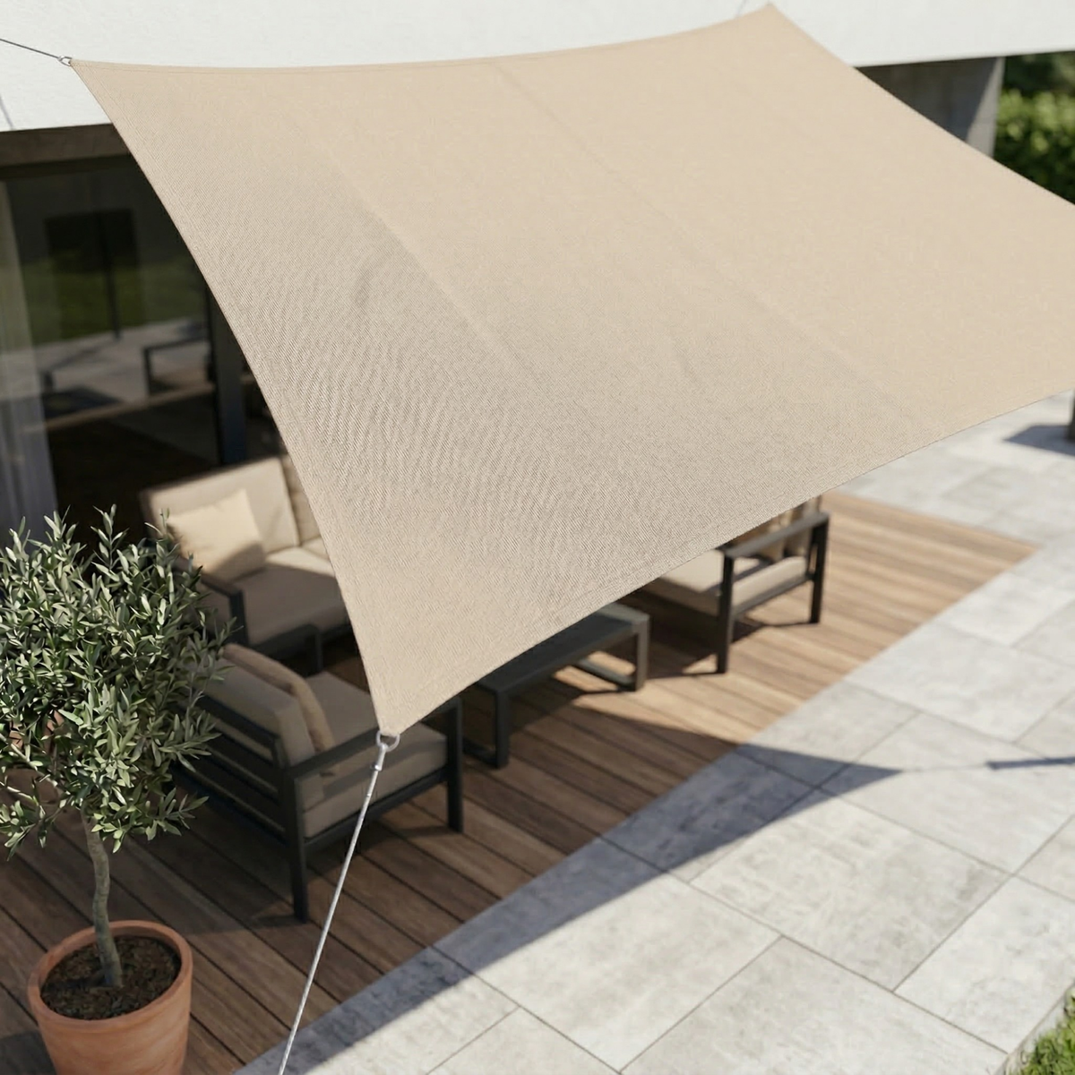 Waterproof UV shade sail in beige, triangular canopy stretched beside outdoor seating