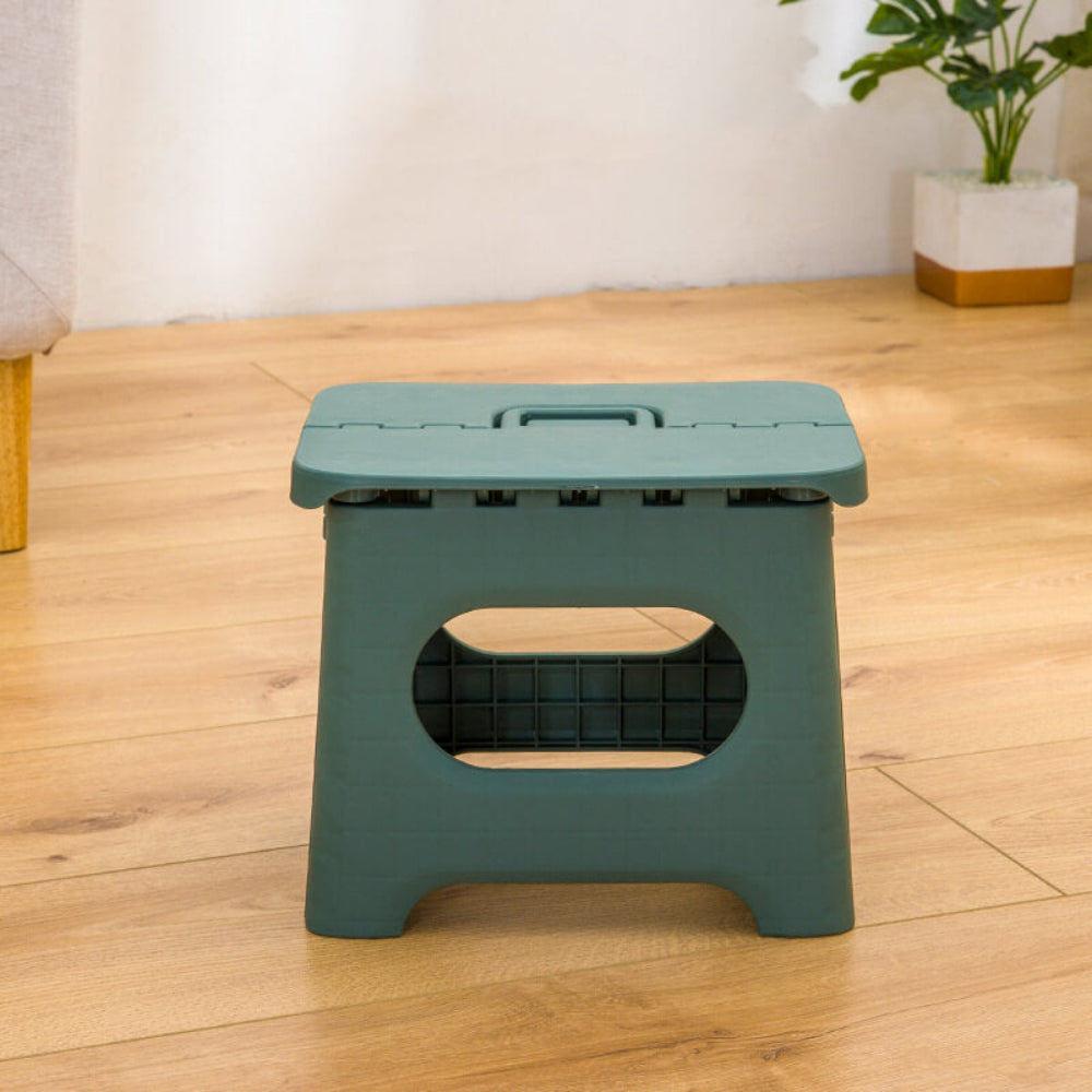 Foldable step stool in teal with oval safety cutout and top carrying handle.