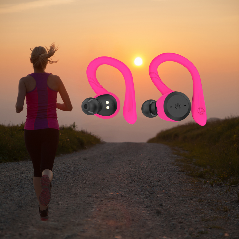 Pink wireless sport earbuds with ear hooks shown outdoors, left and right earbuds