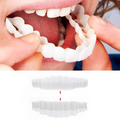 Cosmetic dental veneers held over teeth, clear white snap-on fit