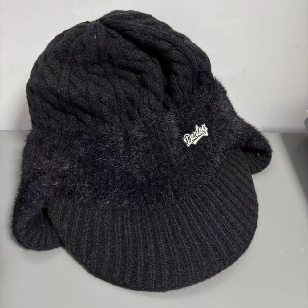 Black knit trapper ear flap hat with Derlog logo patch and ribbed brim