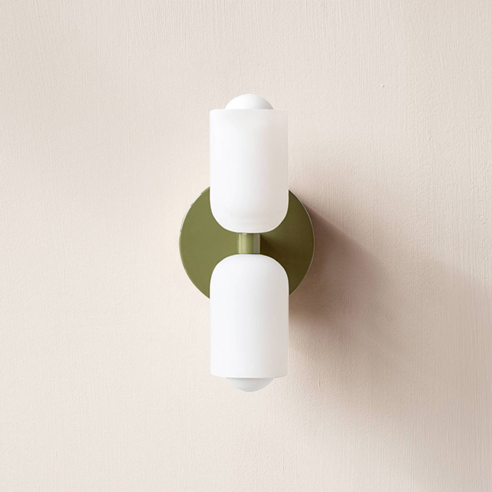 Green wall sconce lamp with two frosted cylindrical acrylic shades and circular backplate