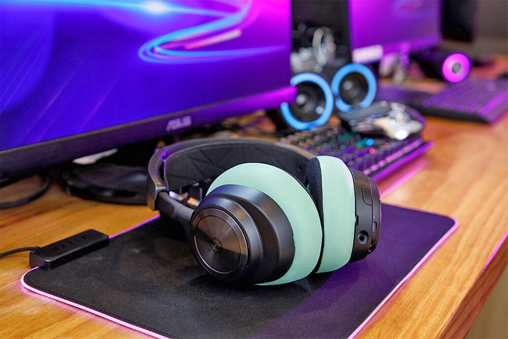 Cooling gel replacement ear pads installed on wireless headphones, mint and black cushions