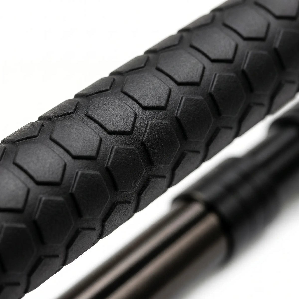 Close-up of a black bicycle tire with tread pattern on a white background