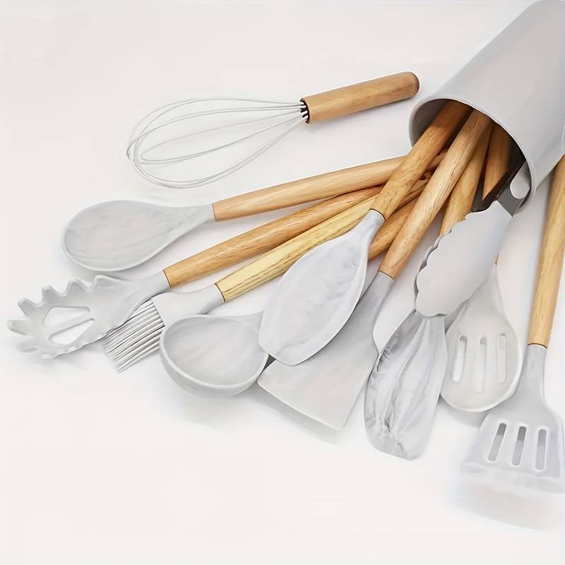 White silicone kitchen utensil set with light wood handles: spatulas, ladle, whisk