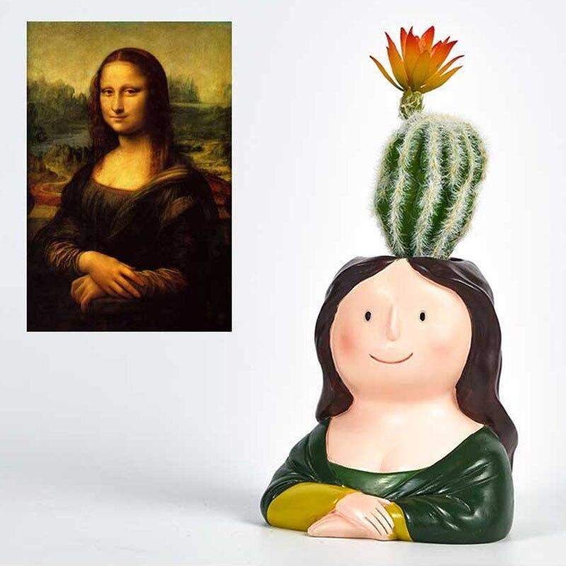 A novelty ceramic planter shaped like a smiling Mona Lisa woman with a cactus on her head and a small orange flower, shown beside a printed inset of the Mona Lisa painting on a white background.