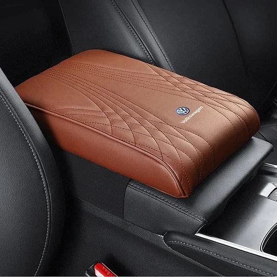 Car armrest cushion cover with brown gradient color, quilted stitching, and logo badge