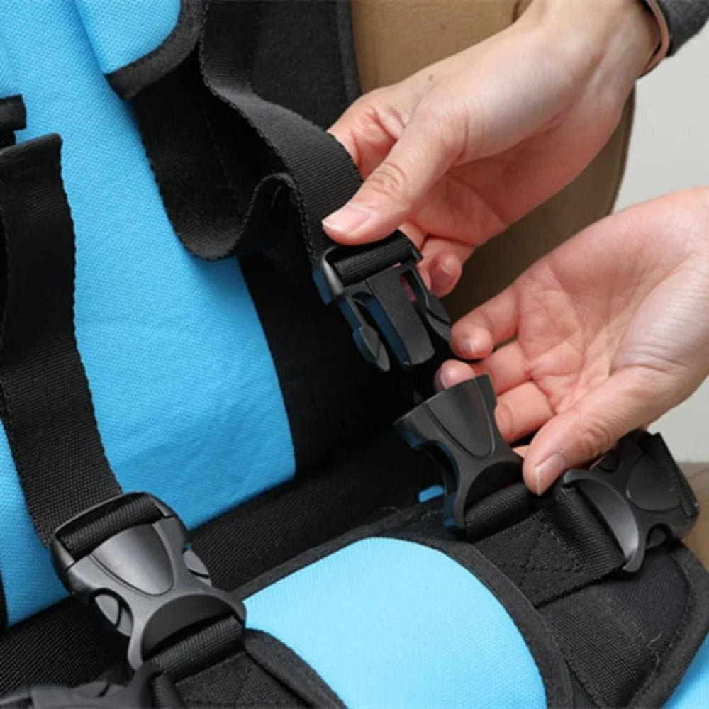 Close-up of blue kids seat safety harness buckle and adjustable webbing straps