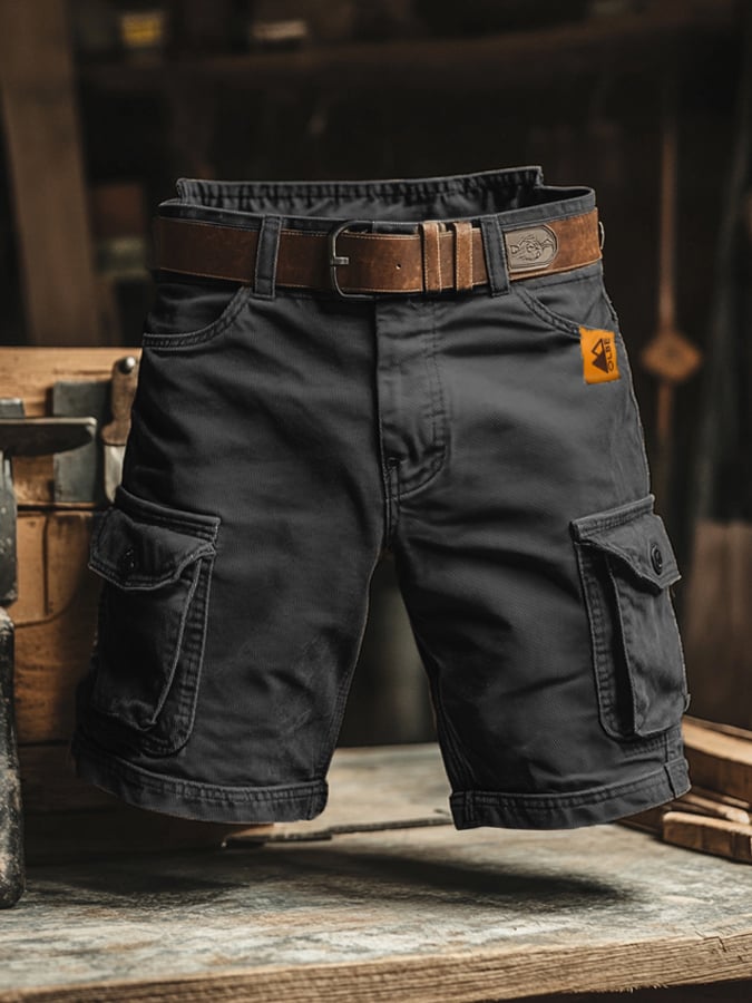 Black men’s cargo shorts with flap pockets, button fly, and belt with metal buckle