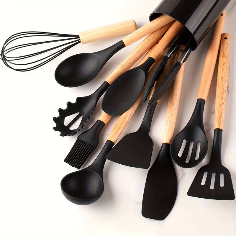 Black silicone kitchen utensil set with light wood handles: whisk, spatulas, ladle