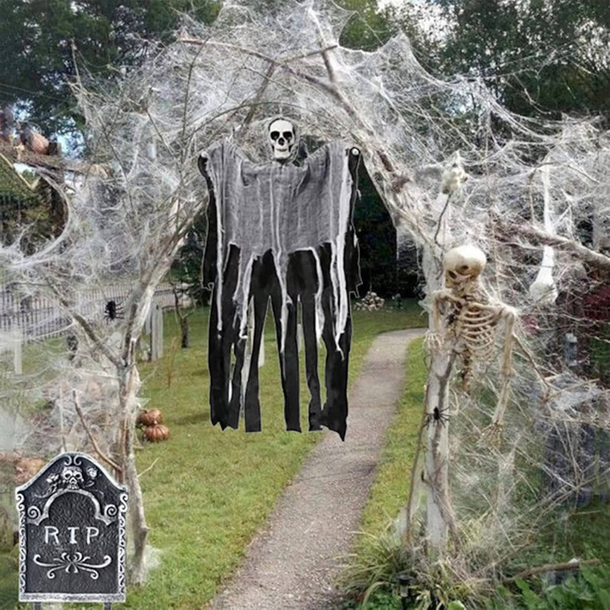 Halloween spider web decoration with white web and dangling black strands, hanging spiders