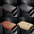 Four car armrest cushion covers shown in black, brown, and beige with car-logo badges