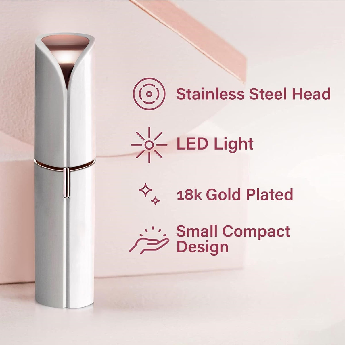 Silver handheld facial hair trimmer with rose gold-tipped stainless steel head