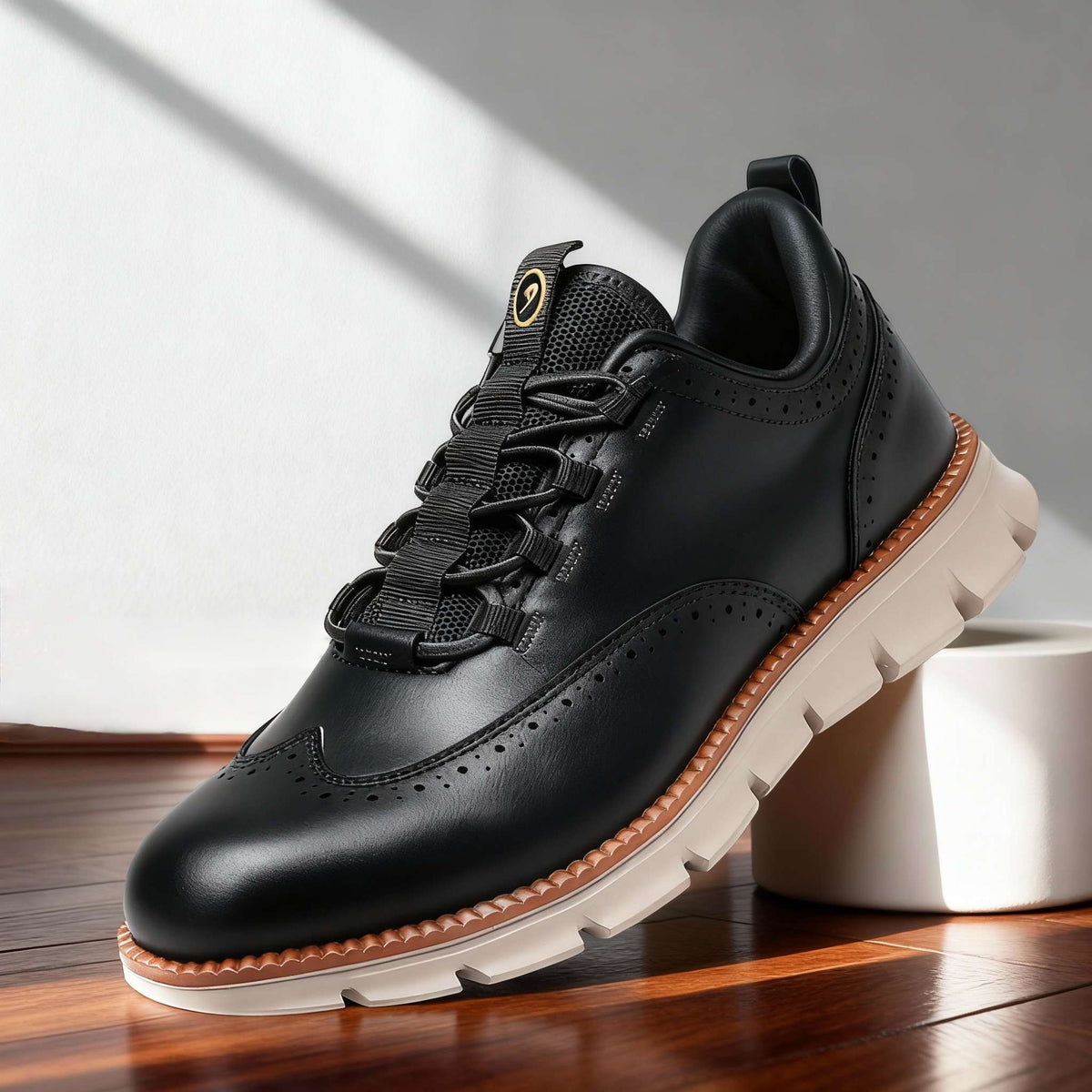 Black perforated lace-up high-top sneakers with padded collar and tan edge sole