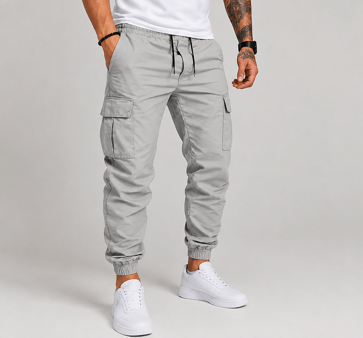 Light grey cargo jogger pants with drawstring waist, cargo pockets, and elastic ankle cuffs