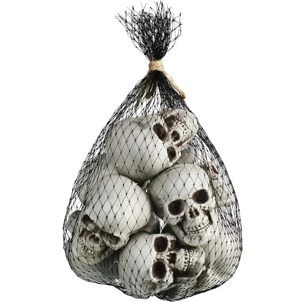Mini white skeleton skull decorations in a black mesh sack, skulls bundled together