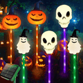 Solar Halloween ground lights with glowing pumpkin, skull, and ghost figures on stakes