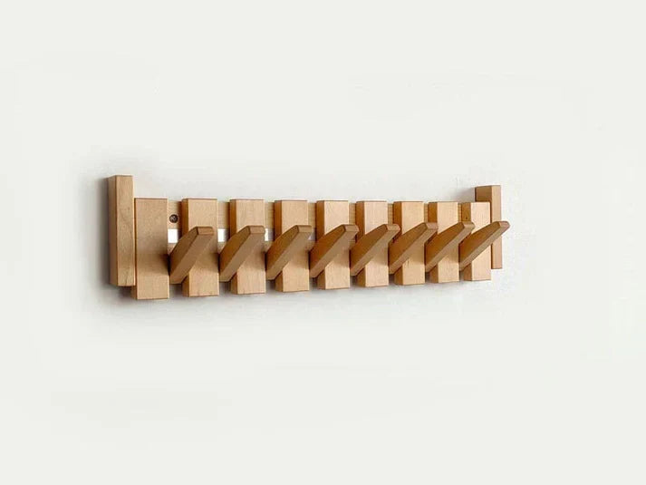 Light wooden fold-out wall hook rack with multiple hinged hooks and mounting holes