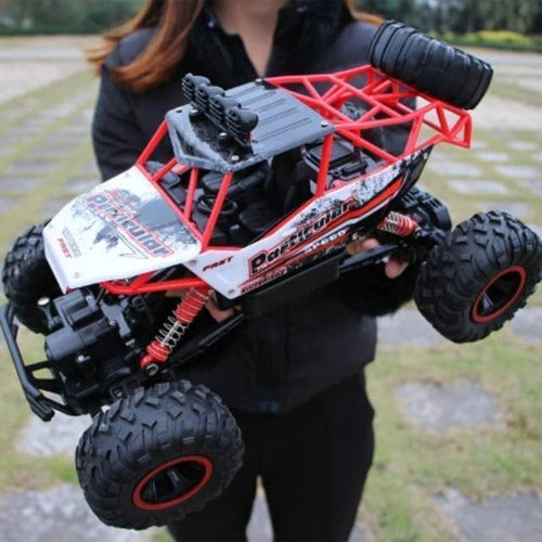 Red remote control crawler truck with large tread tires and front roll cage frame